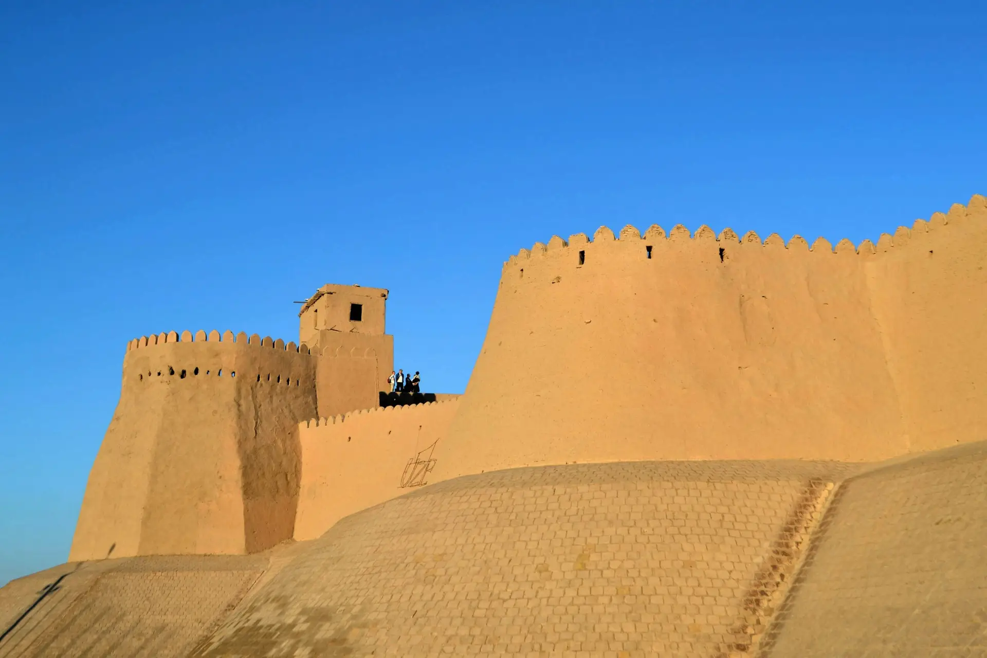 Adobe walls of Khiva, ancient Silk Road city in Uzbekistan, against deep blue sky